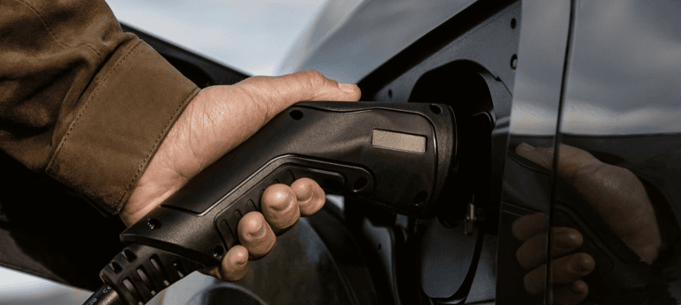 tight shot of plugging in charger into phev